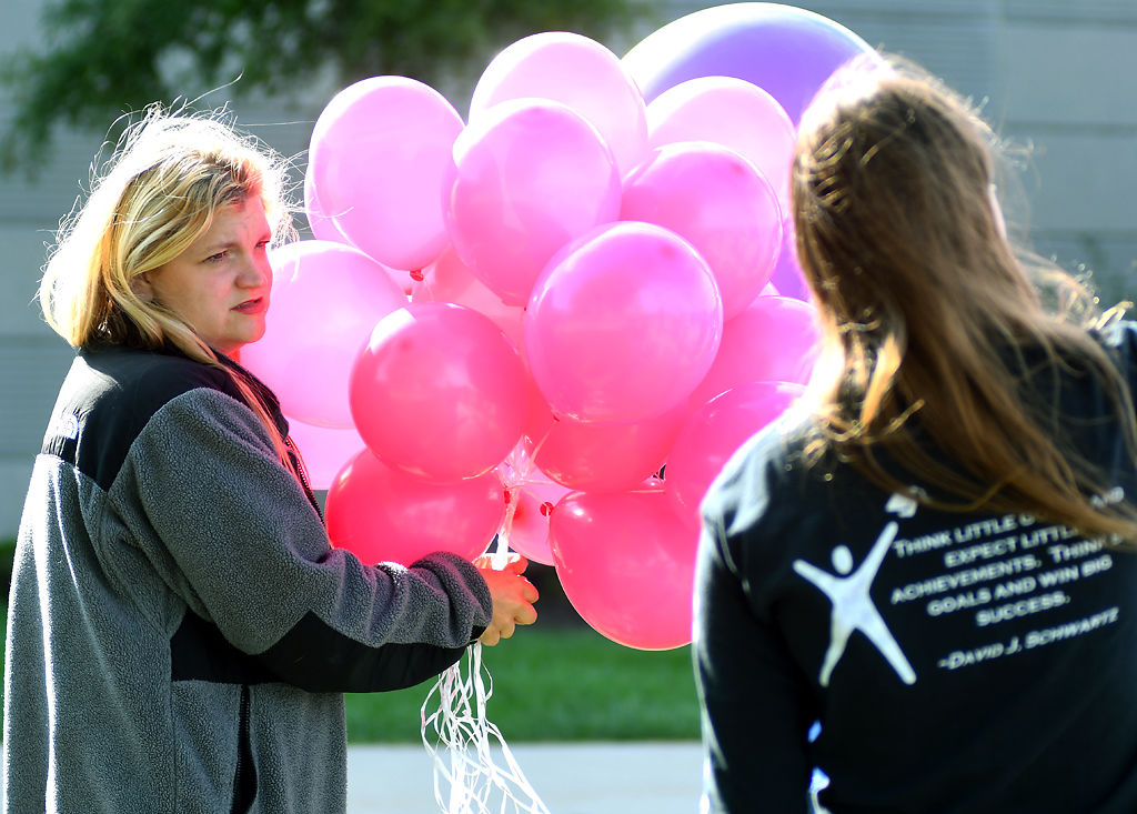 Cheyenne Curry holds a bundle of balloons Friday at Battle High School in Columbia. I